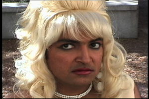 Anuj, clean-shaven and in a large blond wig, performs the character of Ruby.