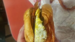 A hamburger topped with a fried egg and bacon from JackInTheBox