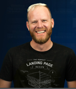 Oli Gardner wearing a funny tee shirt depicting a humorous landing page recipe 
